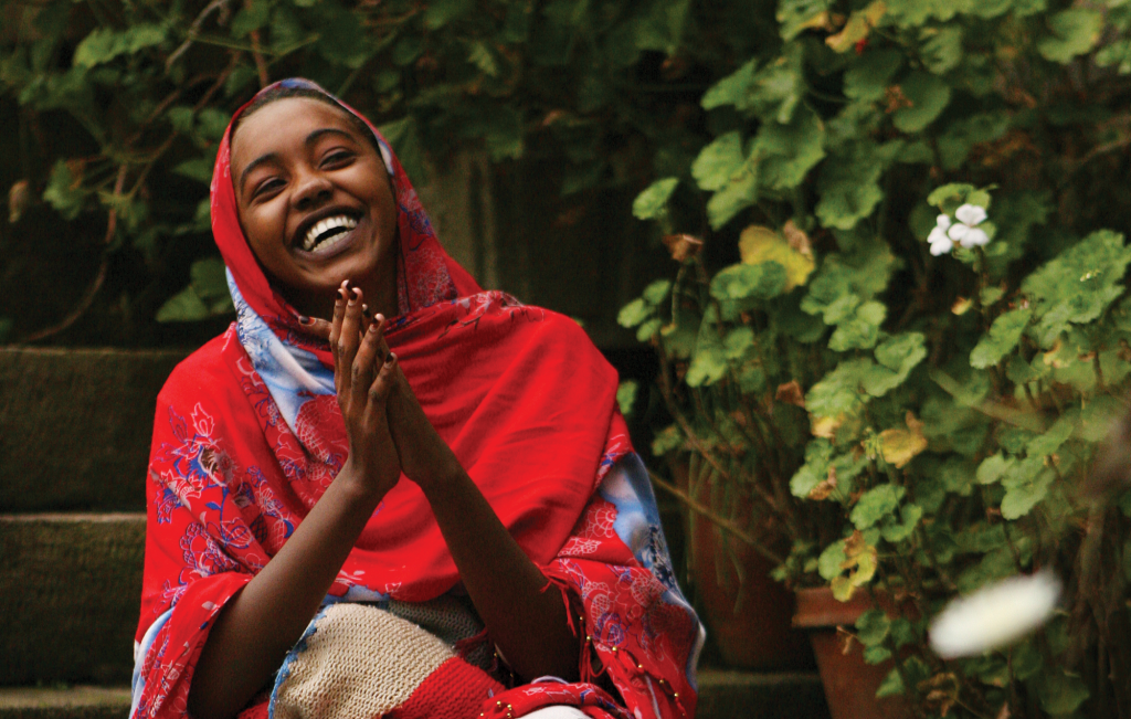 A fistula patient laughing in the gardens of Hamlin's Addis Ababa Fistula Hospital | International Women's Day 2022