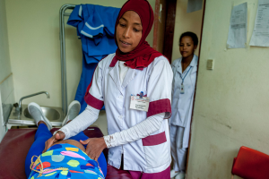 Midwife examining patient